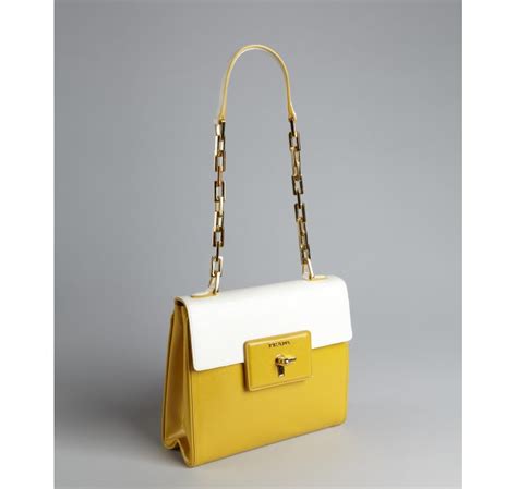 white leather prada with yellow strap